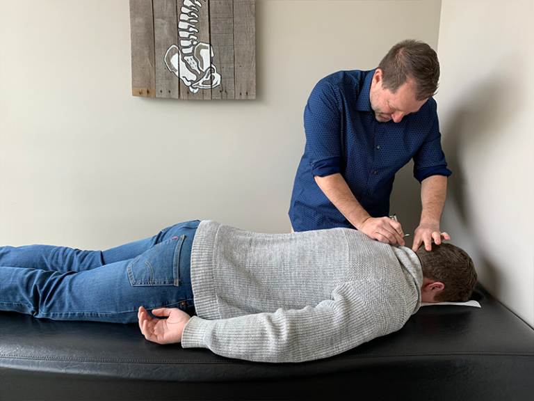 Photo of Doctor Brian Martin working on a patient of Life Force Chiropractic