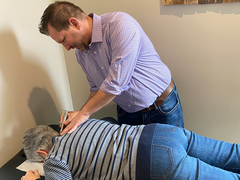 Photo of Doctor Brian Martin working on a patient of Life Force Chiropractic