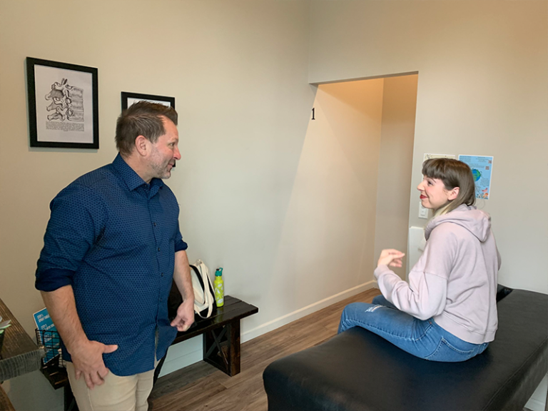 Photo of Doctor Brian speaking to patient at Life Force Chiropractic